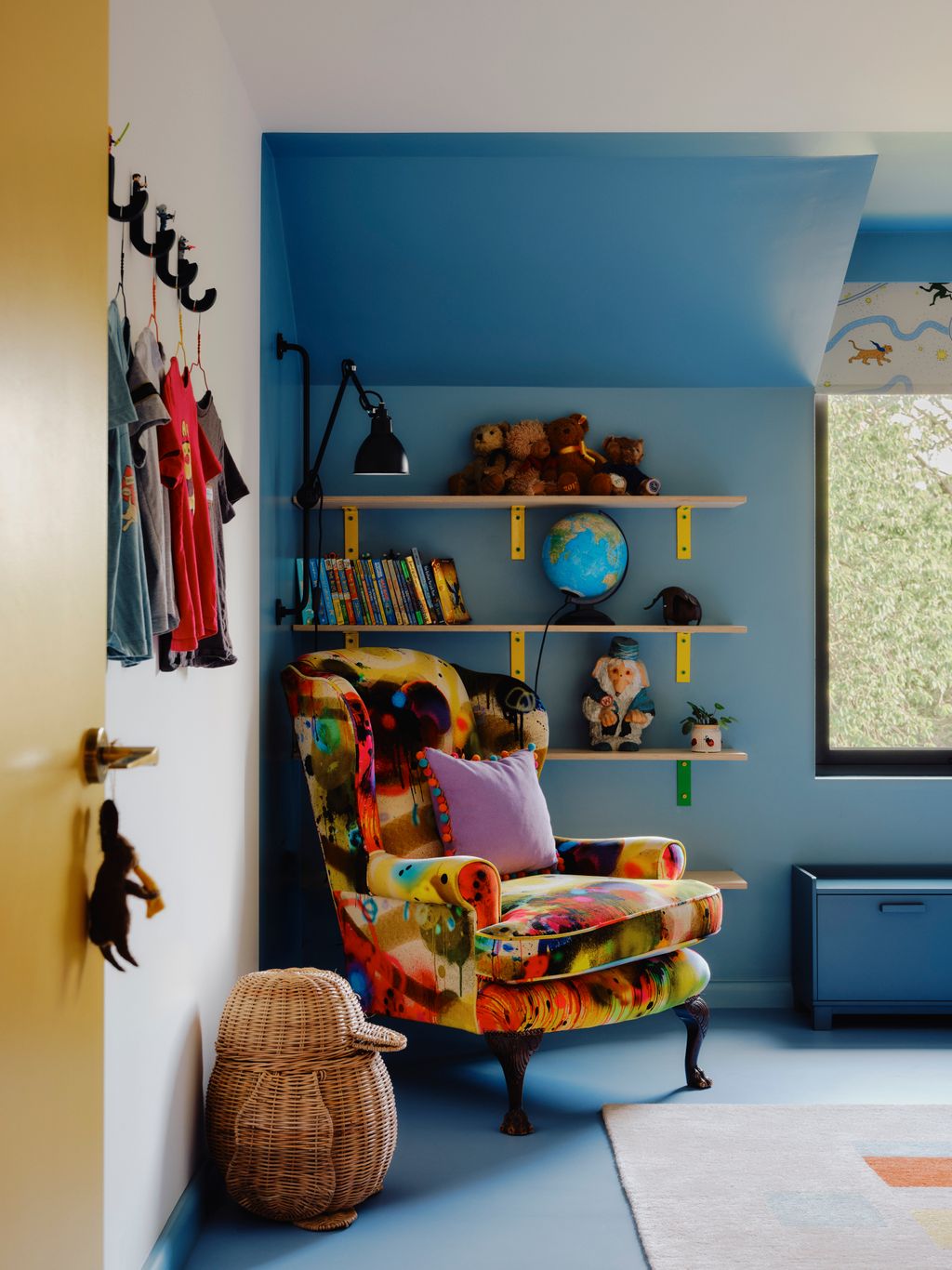 A blue linoleum floor with matching walls zones the room where Clares grandfathers chair is reupholstered in Timorous...