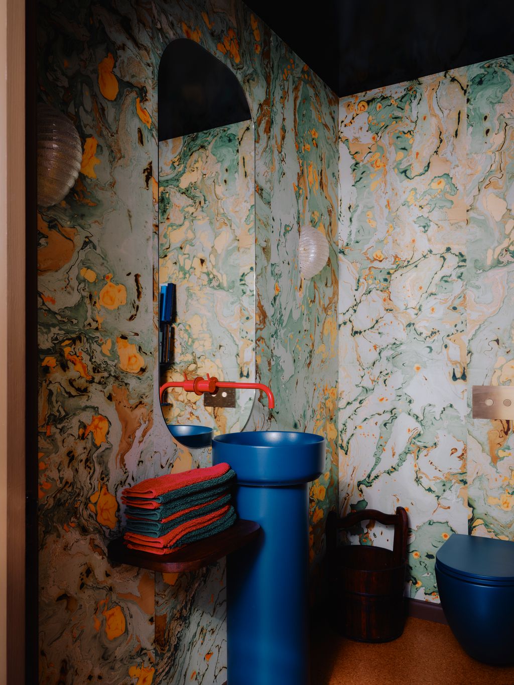 In the downstairs loo vintage Murano wall lights from ReHaus hang above marbled walls by Nat Maks created with Clare and...