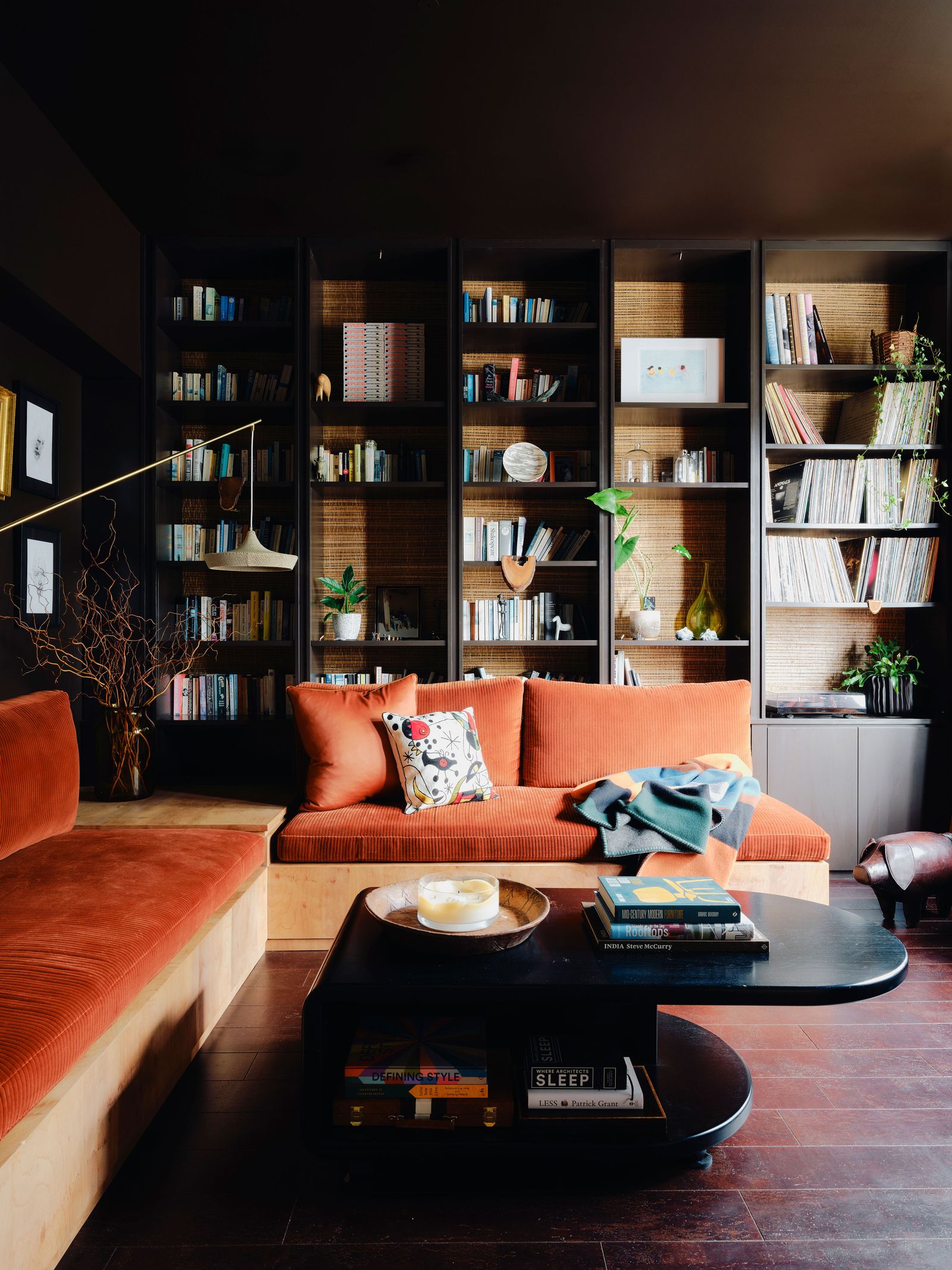 Walls in Benjamin Moores ‘Bittersweet Chocolate frame a bespoke bookcase and seating by Clare lined with Schumachers...