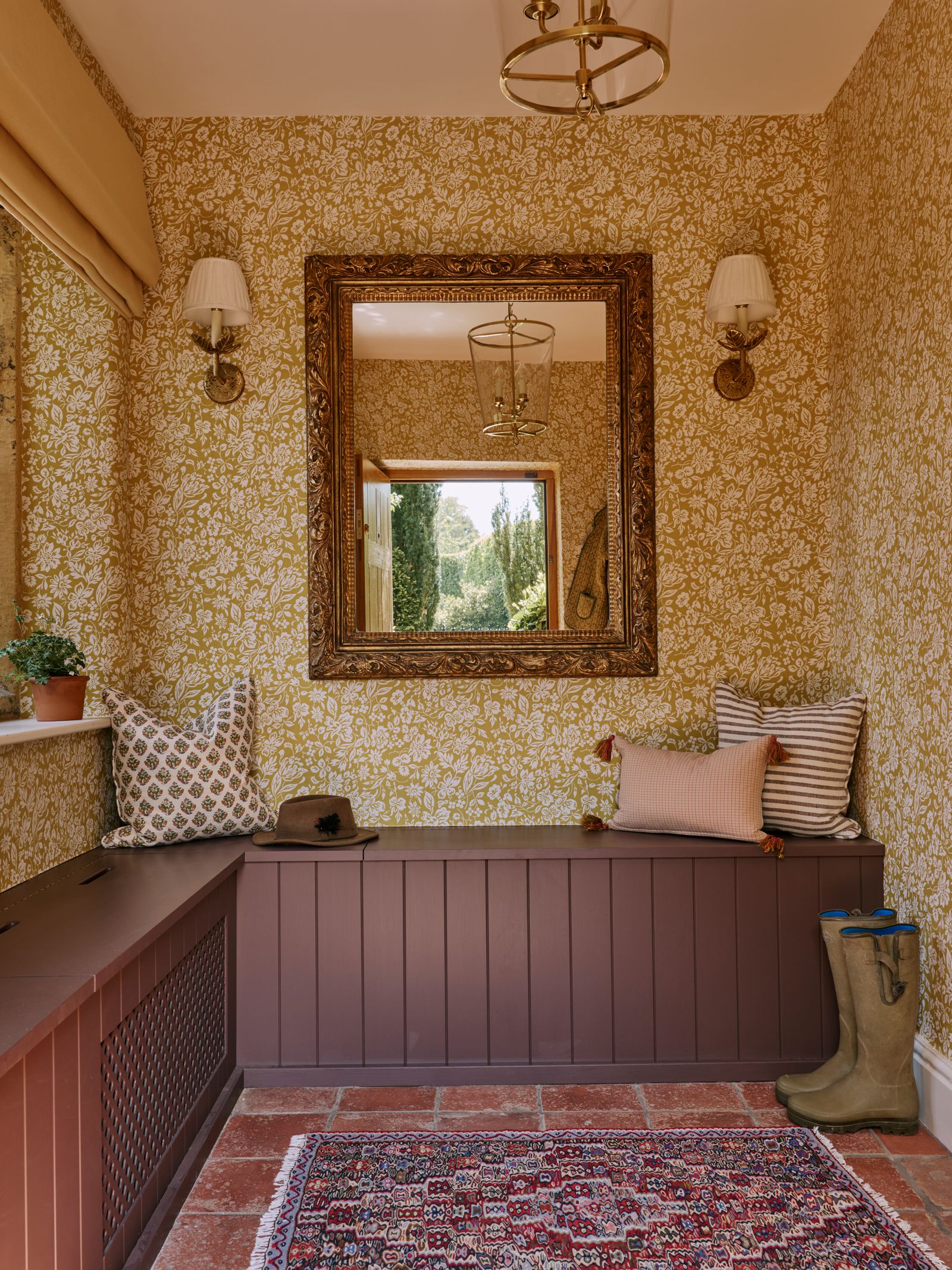 In this entrance hall in a Cotswold house by Lucy Cunningham wallpaper in Soane's ‘Berlioz design in sunflower plays...