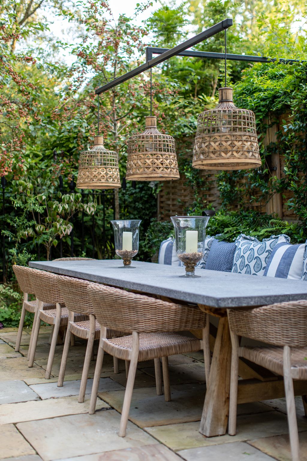 A table from Oxenwood John Lewis chairs and lights from Design Vintage create a comfortable spot for outdoor dining. The...