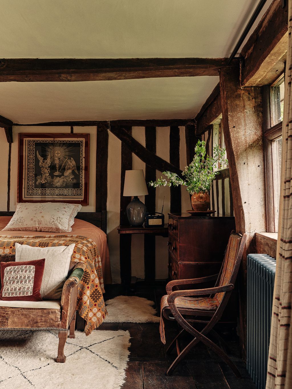In the spare room of this 17thcentury house in Suffolk by Retrouvius a vintage Welsh blanket on the bed picks up on...