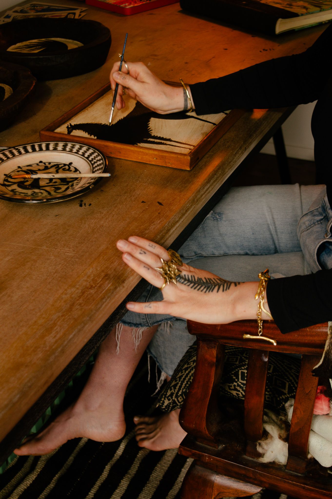 Tabby Booth painting in her signature silhouette style