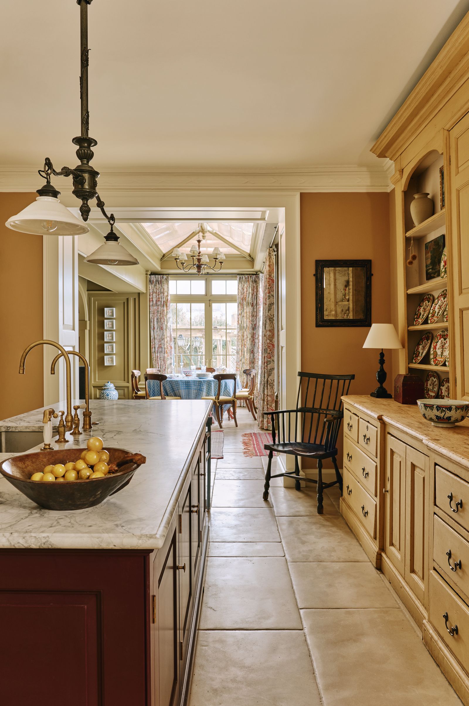 The 18thcentury housekeepers painted pine dresser in the kitchen inspired the design of the oak cabinetry by Guild...