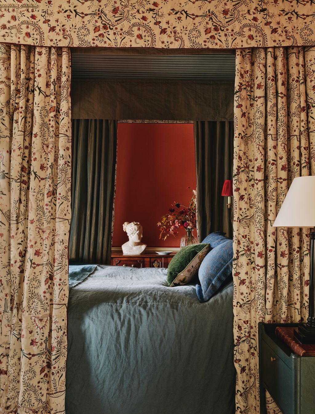 In the main bedroom the walls are covered in Claremonts ‘Drap de Soie in rouge while Maxs bespoke ‘Chamberlayne...
