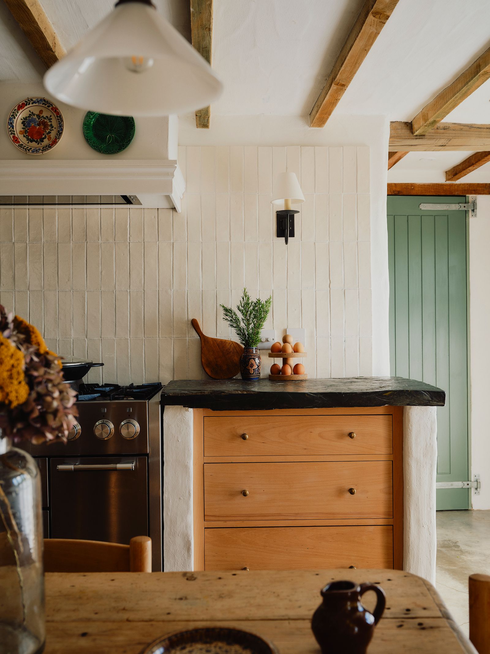 The tiles in the kitchen are from Marlborough Tiles and the wall lights are from Jim Lawrence.