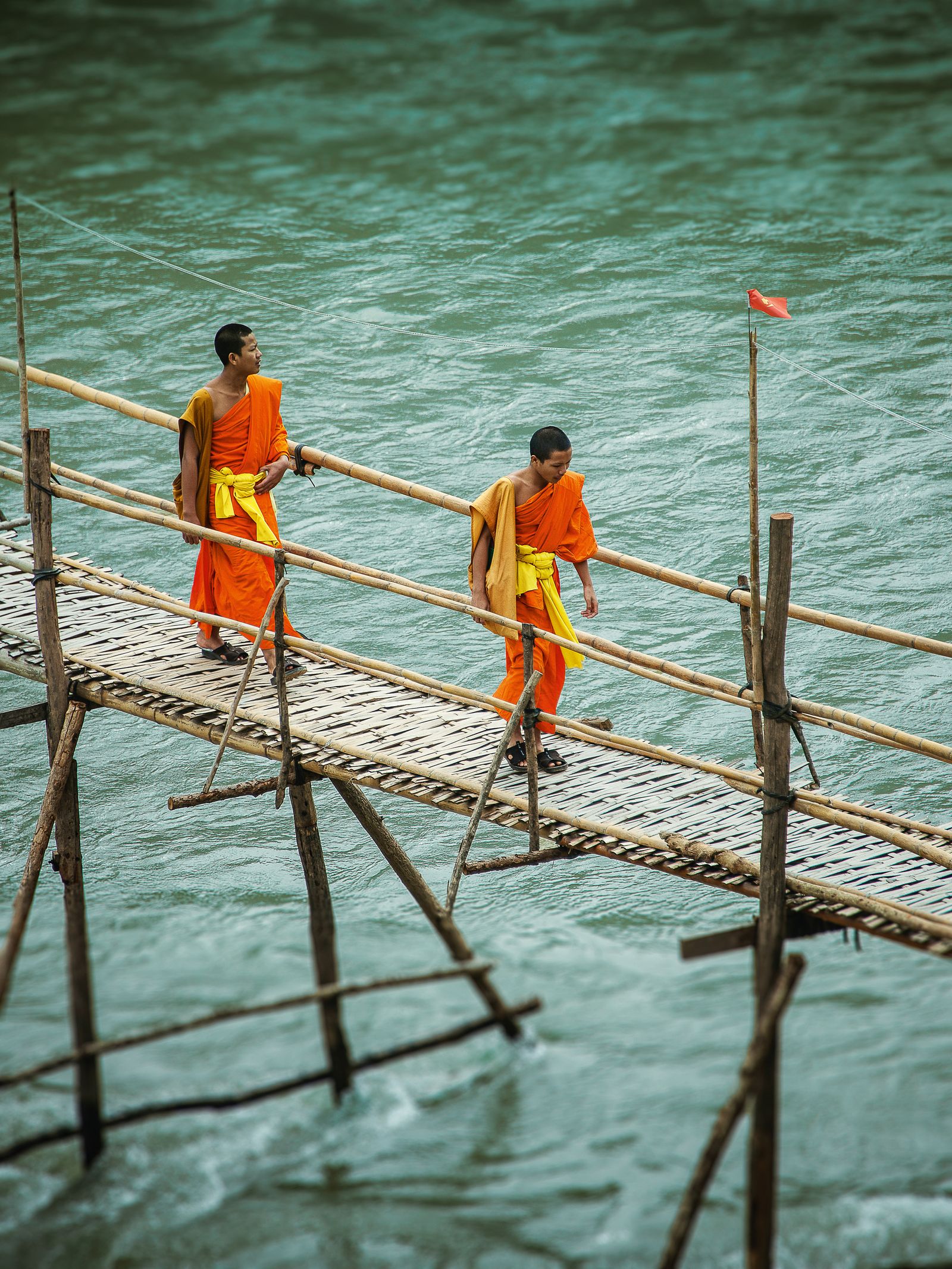 Crossing the river on a bamboo bridge.