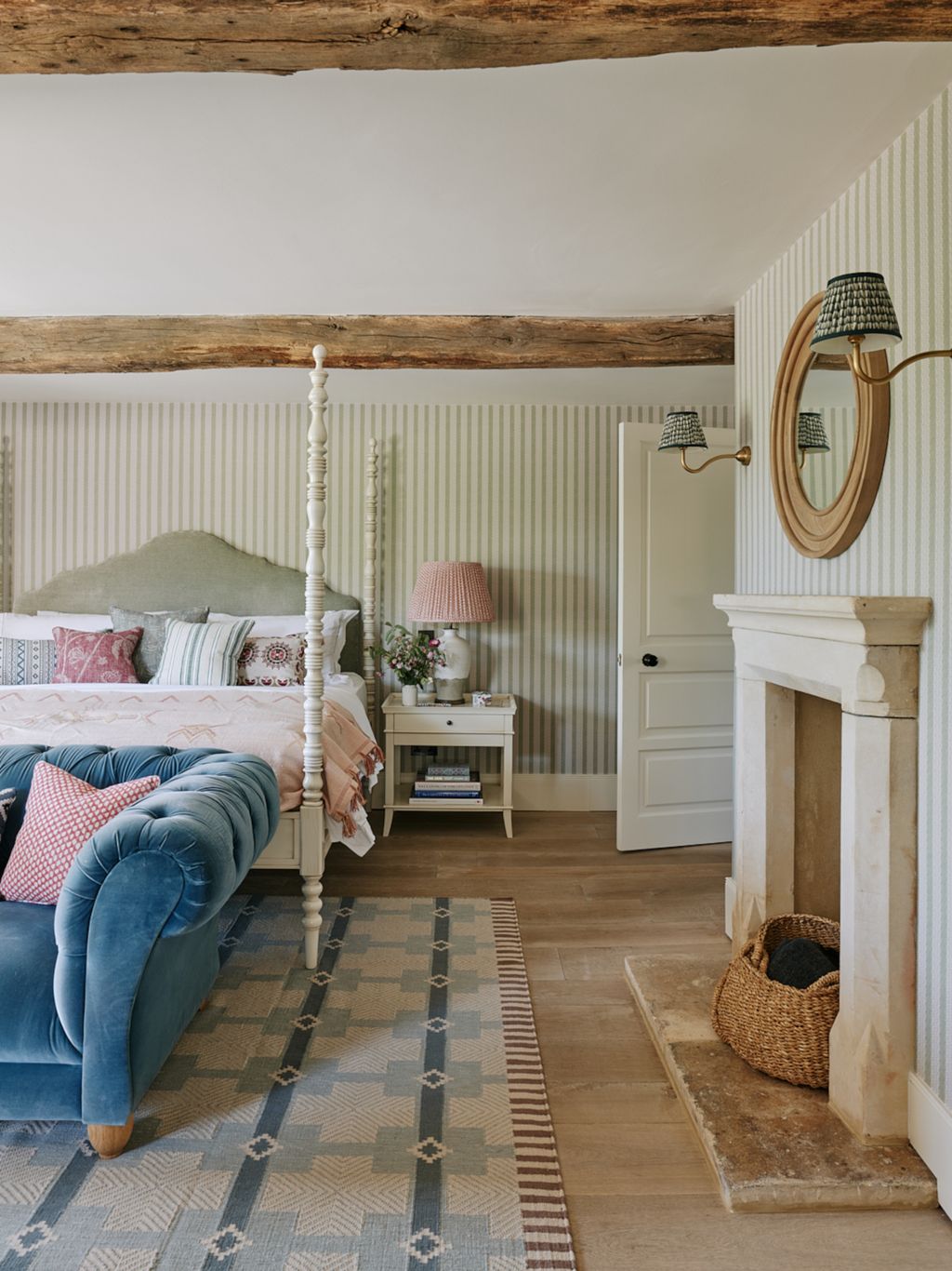 A fourposter bed from the owners previous house is set against walls in ‘Torchon Stripe by Inchyra in the spare room....