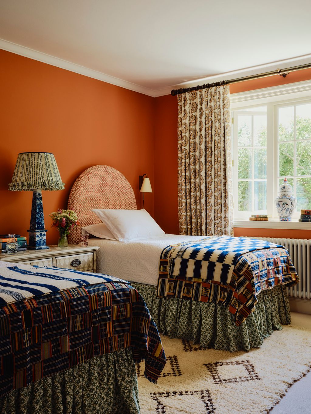 ‘The orange spare bedroom is bright and warm a space our clients imagined for their grandchildren or younger guests...