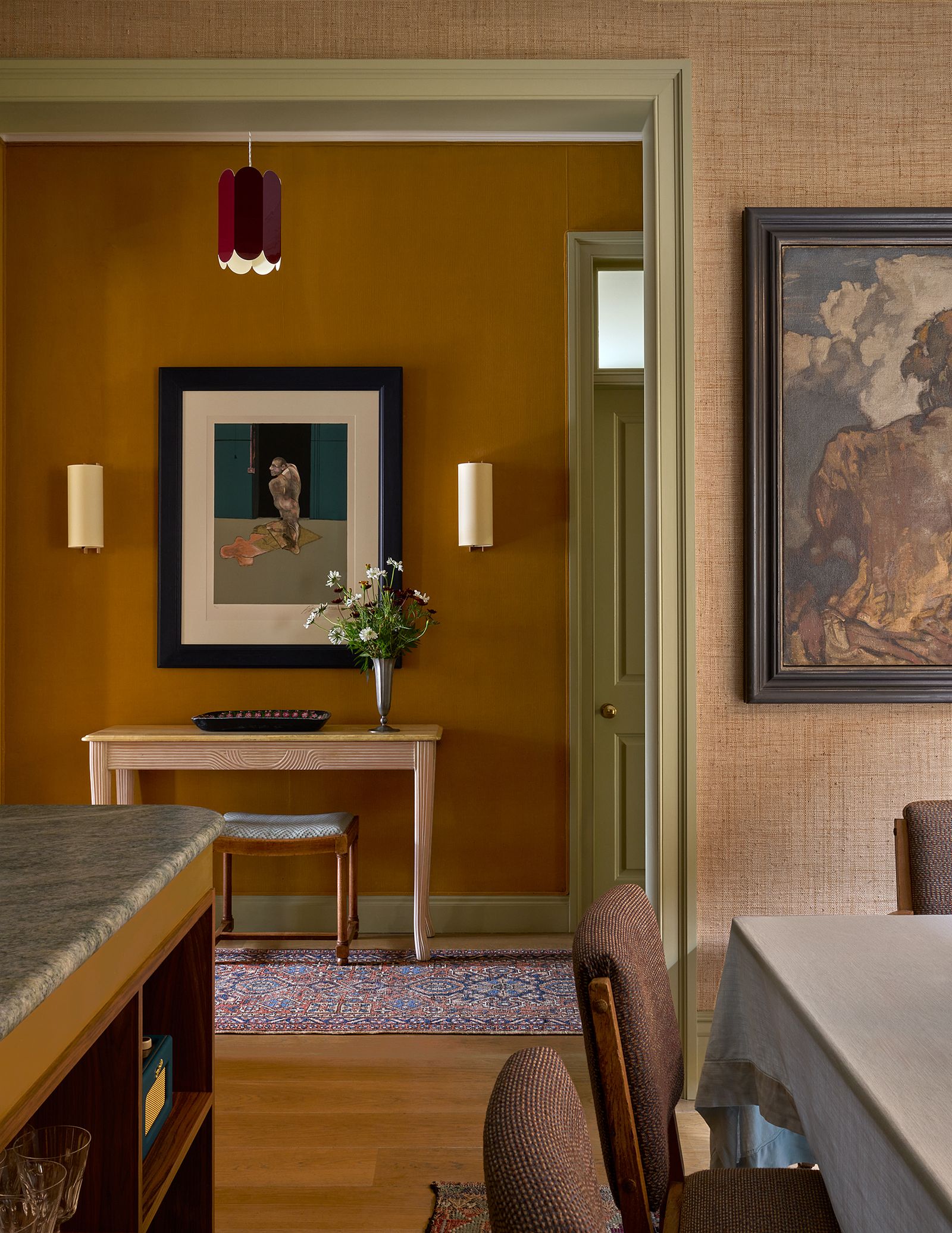 A Francis Bacon lithograph hangs behind a Frank Brangwyn oil painting. The wall lights are from Santa amp Cole.