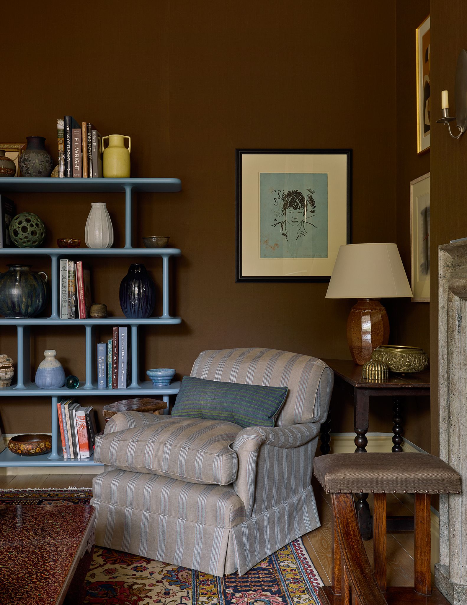 The bright blue shelving unit was designed by Jamie Hayon for ampTradition. It houses a collection of pottery including...