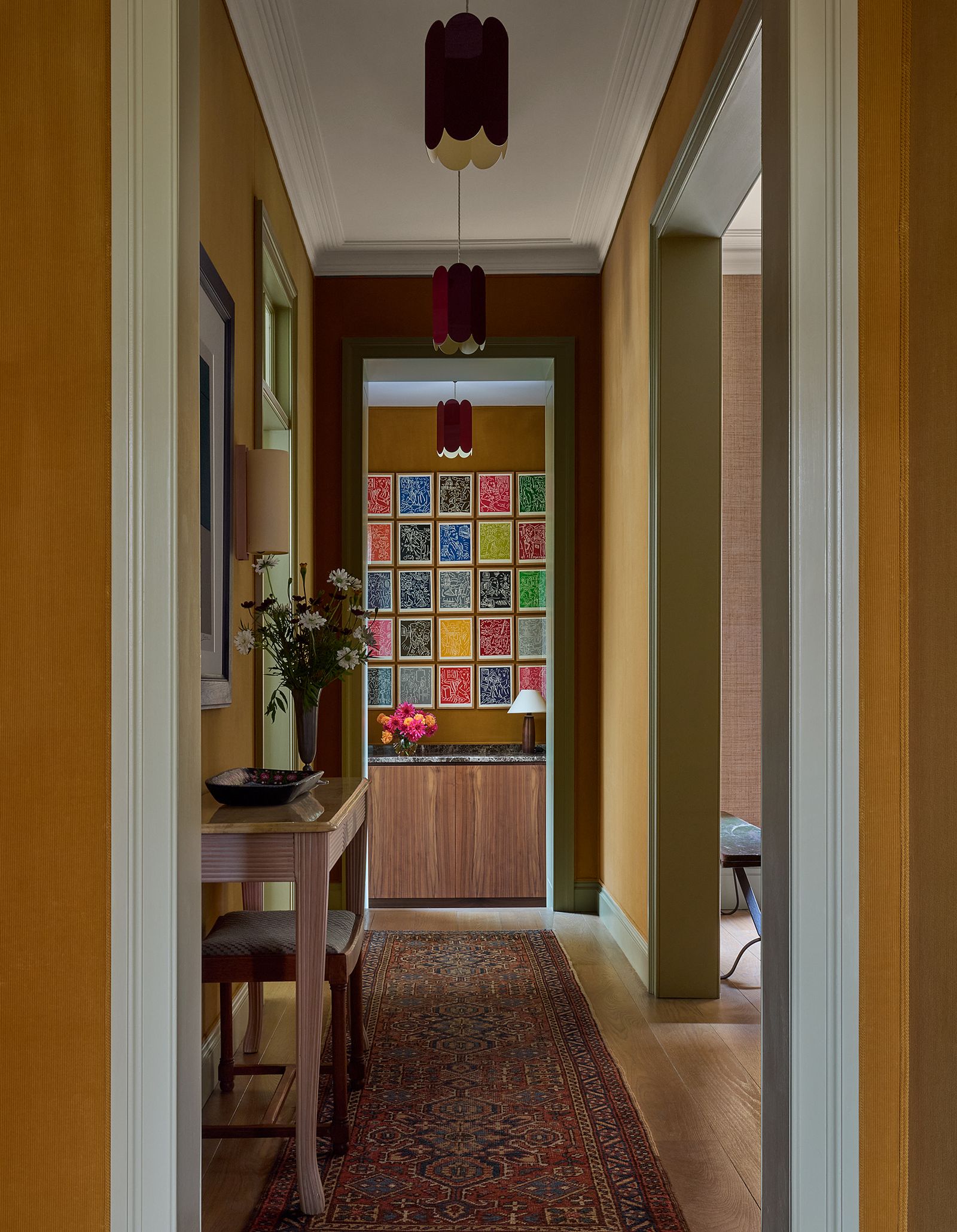 In the entrance hall the walls are swathed in ochre ‘Charlton corduroy fabric from Tissus dHelene. Pendant lights are...