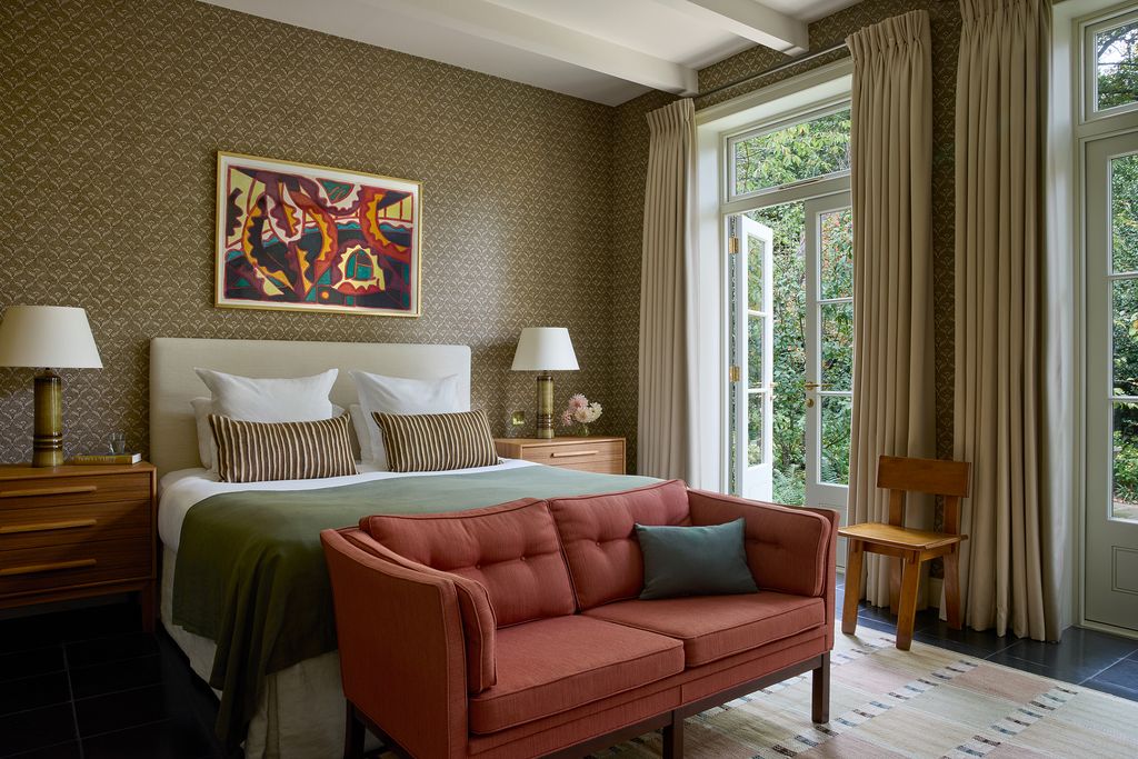 Simple curtains in Holland  Sherrys ‘Andes wool frame views to the garden. A 1930s side chair by American designer...