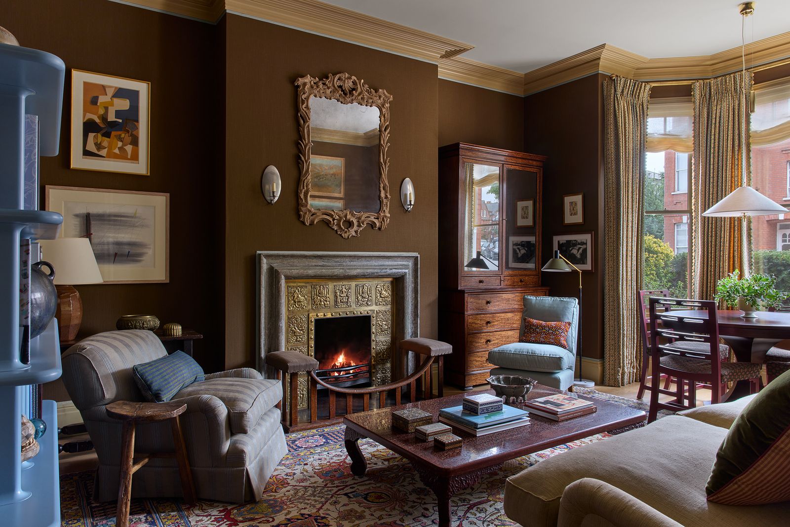 In his London flat designer Brandon Schubert has complemented his brown linen walls and brass fireplace insert with cool...