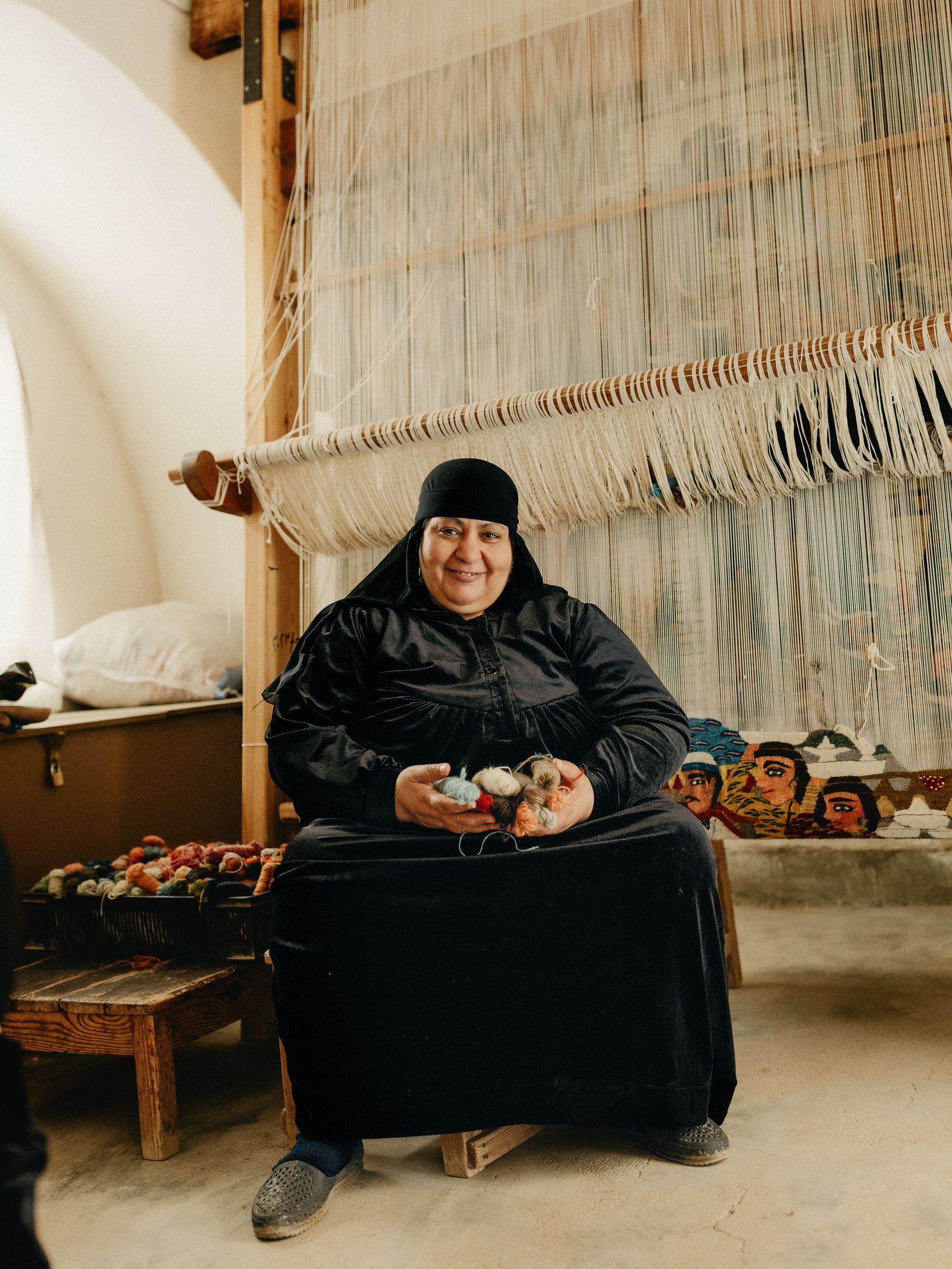 Weaver Reda Ahmed with her Wedding Preparations tapestry on the loom.