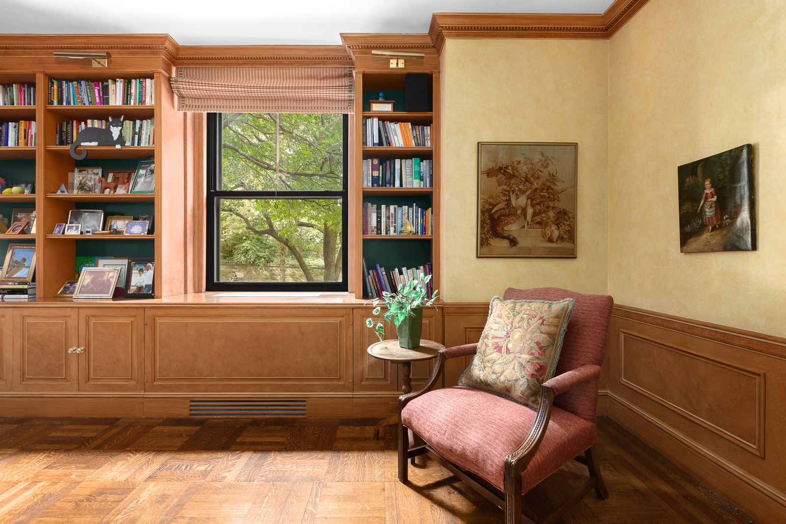 library with wainscoting beige walls builtin bookshelves wood floors