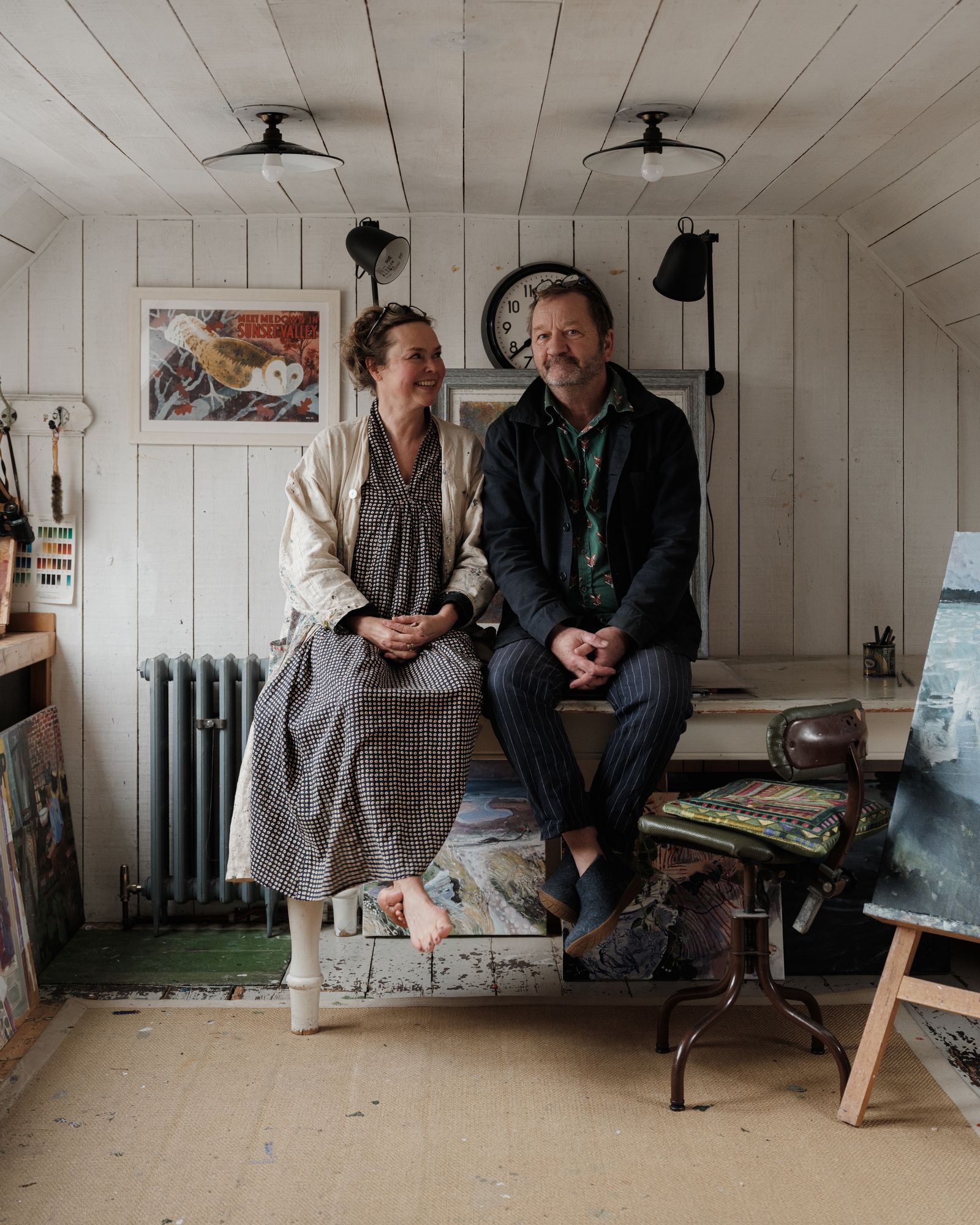 Brita and Mick in their studio at the top of the house. The owl palimpsest to the left is by Mick. Under the table and...