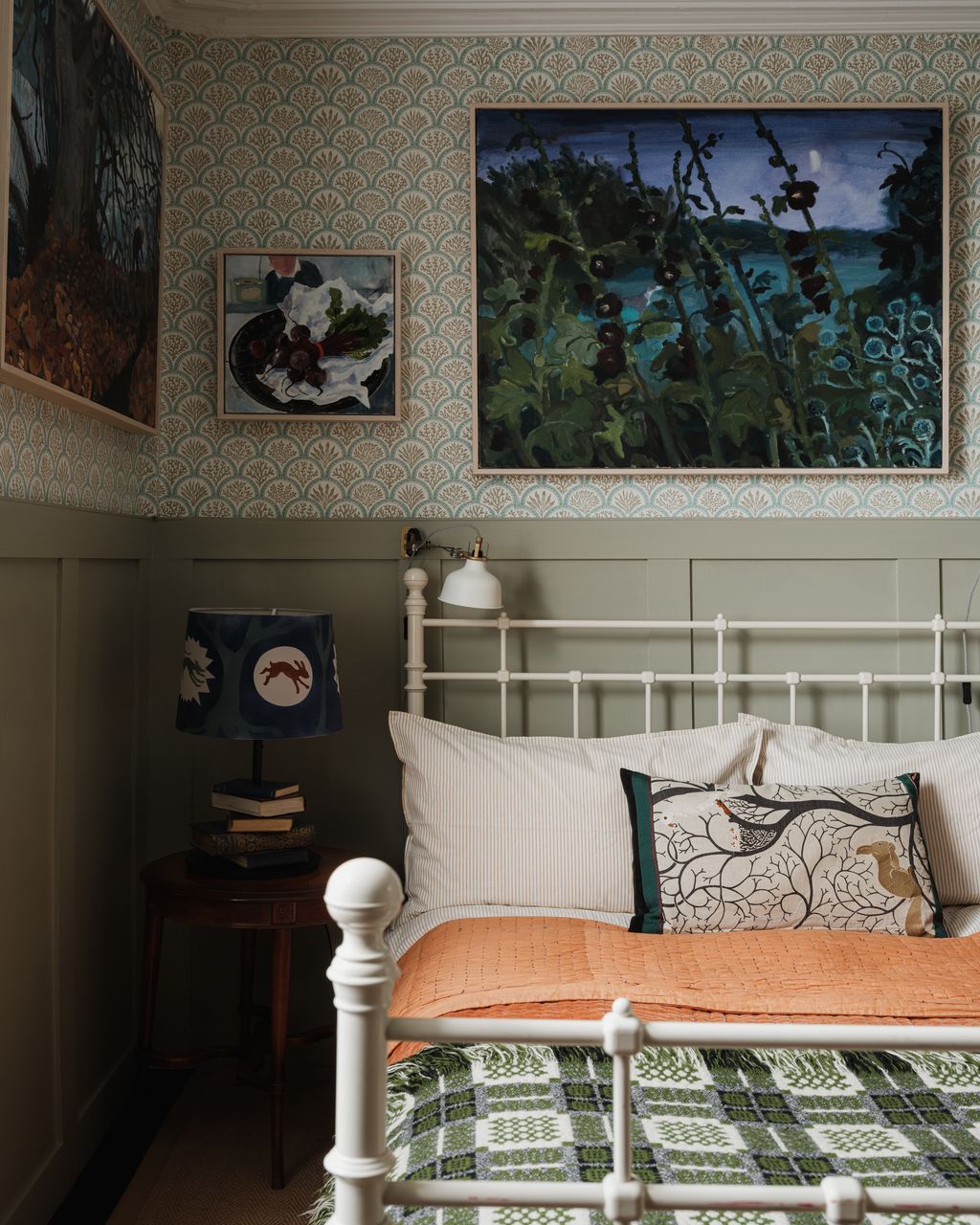 A spare bedroom is decorated with Jane Churchill's ‘Coralli wallpaper with pieces by Brita over the bed. The painted...