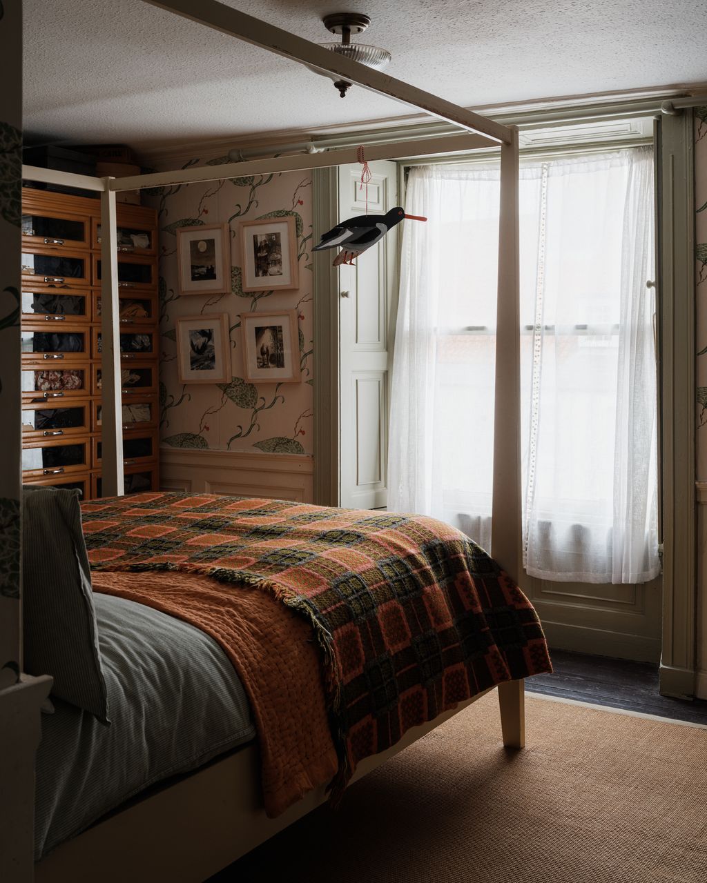 The shutters and panelling are original to the house. A painted cardboard oystercatcher mobile by Brita hangs on the...