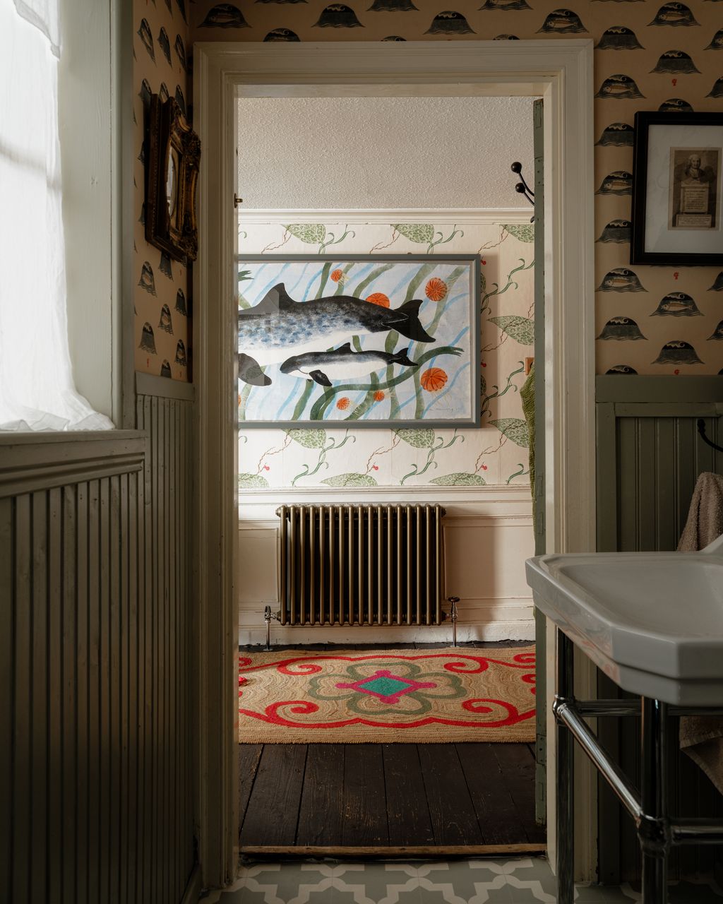 Micks lifesize pochoir painting of a porpoise mother and calf hangs on the wall of the bedroom seen from the ensuite...