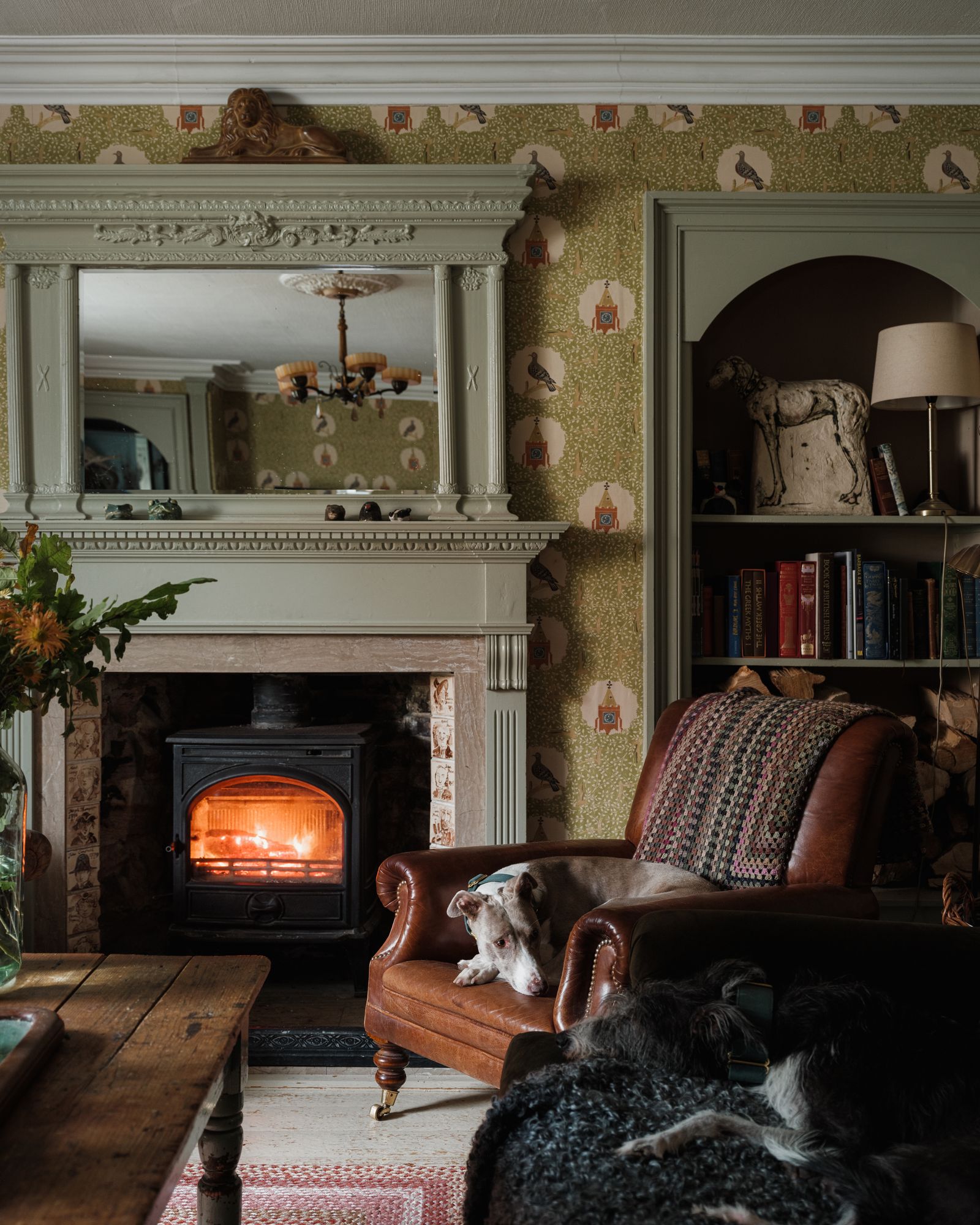 The lurchers Hilda and Nelly at rest in the front sitting room where the wallpaper is Edward Bawden's ‘Pigeon and Clock...