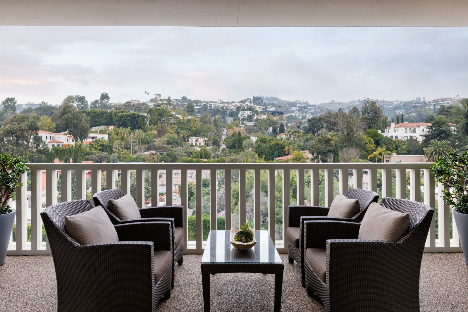 balcony  four matching armchairs around glass topped cocktail table