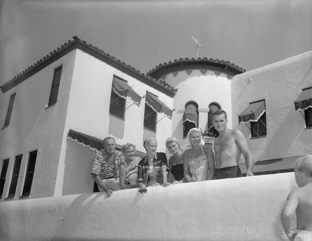 blackandwhite photo of Grace Kelly and family standing posed outside their summer home