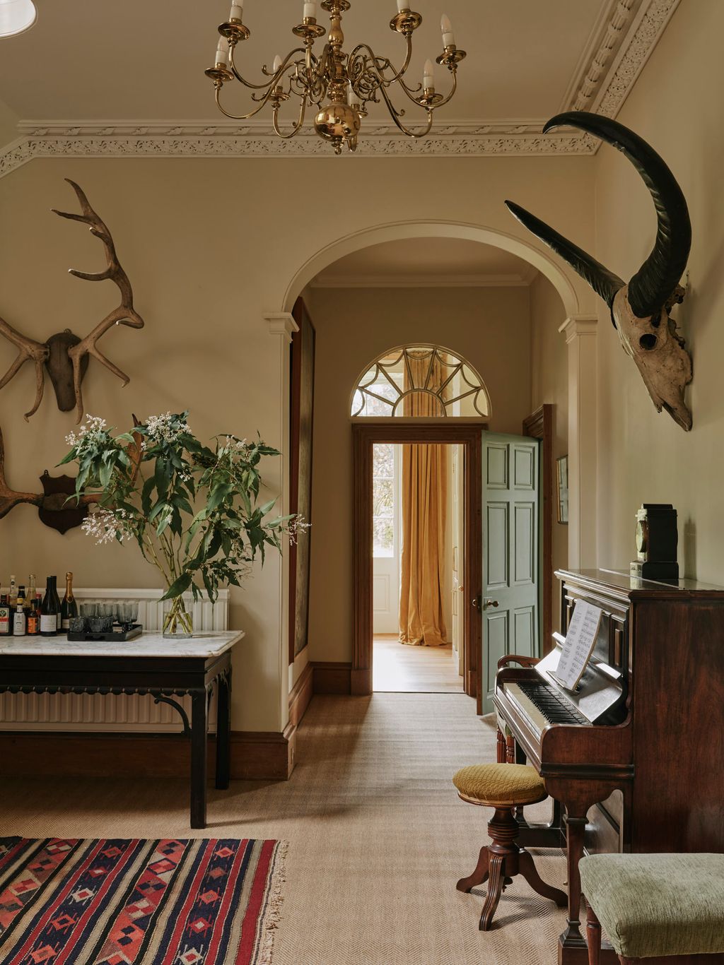 Image may contain Indoors Architecture Building Foyer Keyboard Musical Instrument Piano Chandelier and Lamp