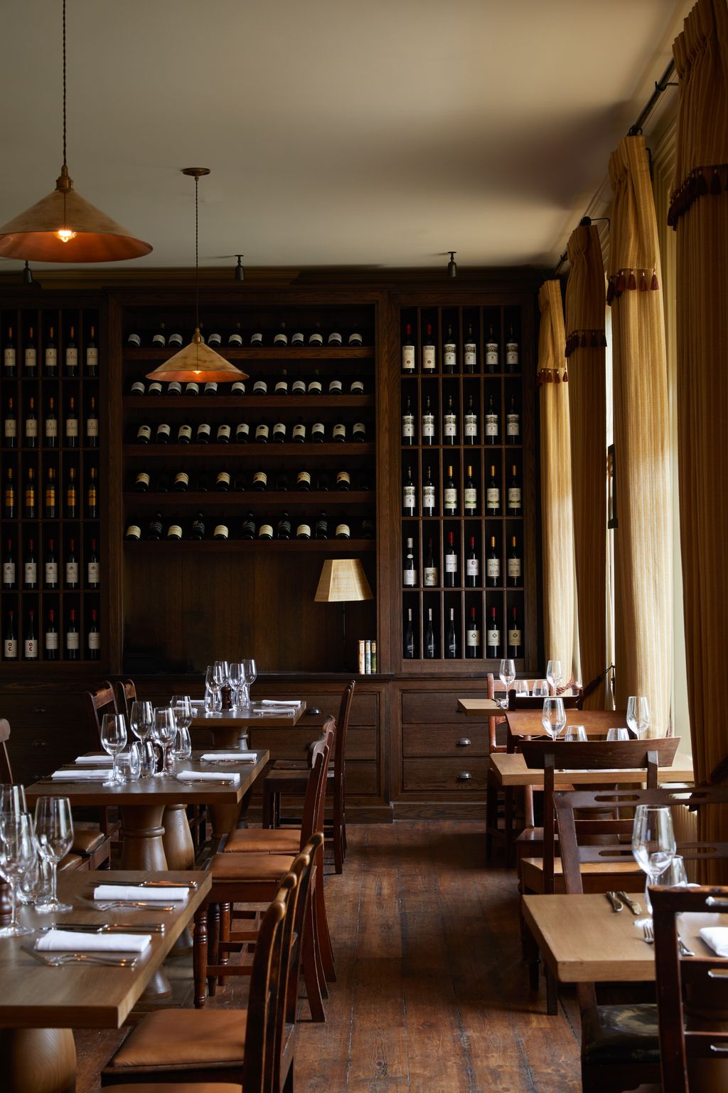 Image may contain Alcohol Beverage Liquor Wine Chair Furniture Lamp Wine Cellar Dining Table and Table