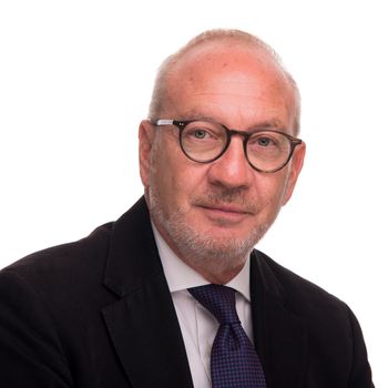 Image may contain: Accessories, Formal Wear, Tie, Face, Head, Person, Photography, Portrait, Glasses, Necktie, and Clothing