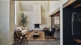 Image may contain Home Decor Indoors Interior Design Rug Furniture Table Coffee Table Floor and Fireplace