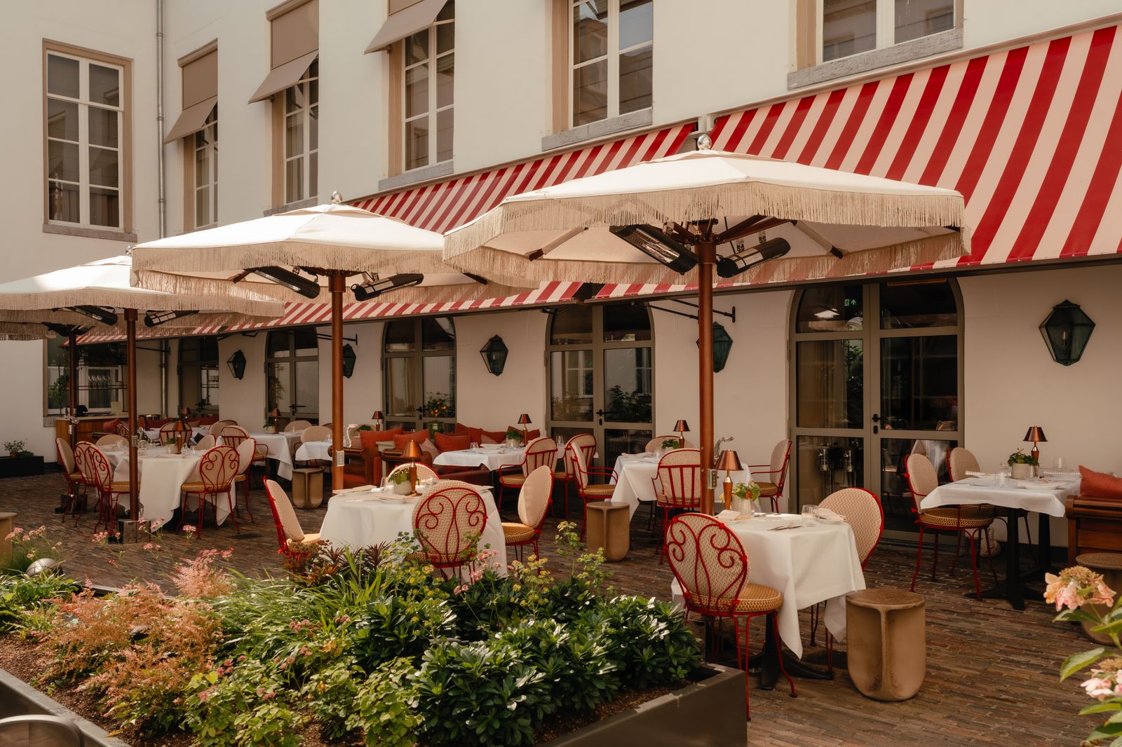 Image may contain Indoors Restaurant Chair Furniture Canopy Table and Dining Table