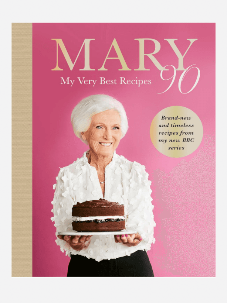 Image may contain: Mary Berry, Adult, Person, People, Publication, Birthday Cake, Cake, Cream, Dessert, Food, Face, and Head