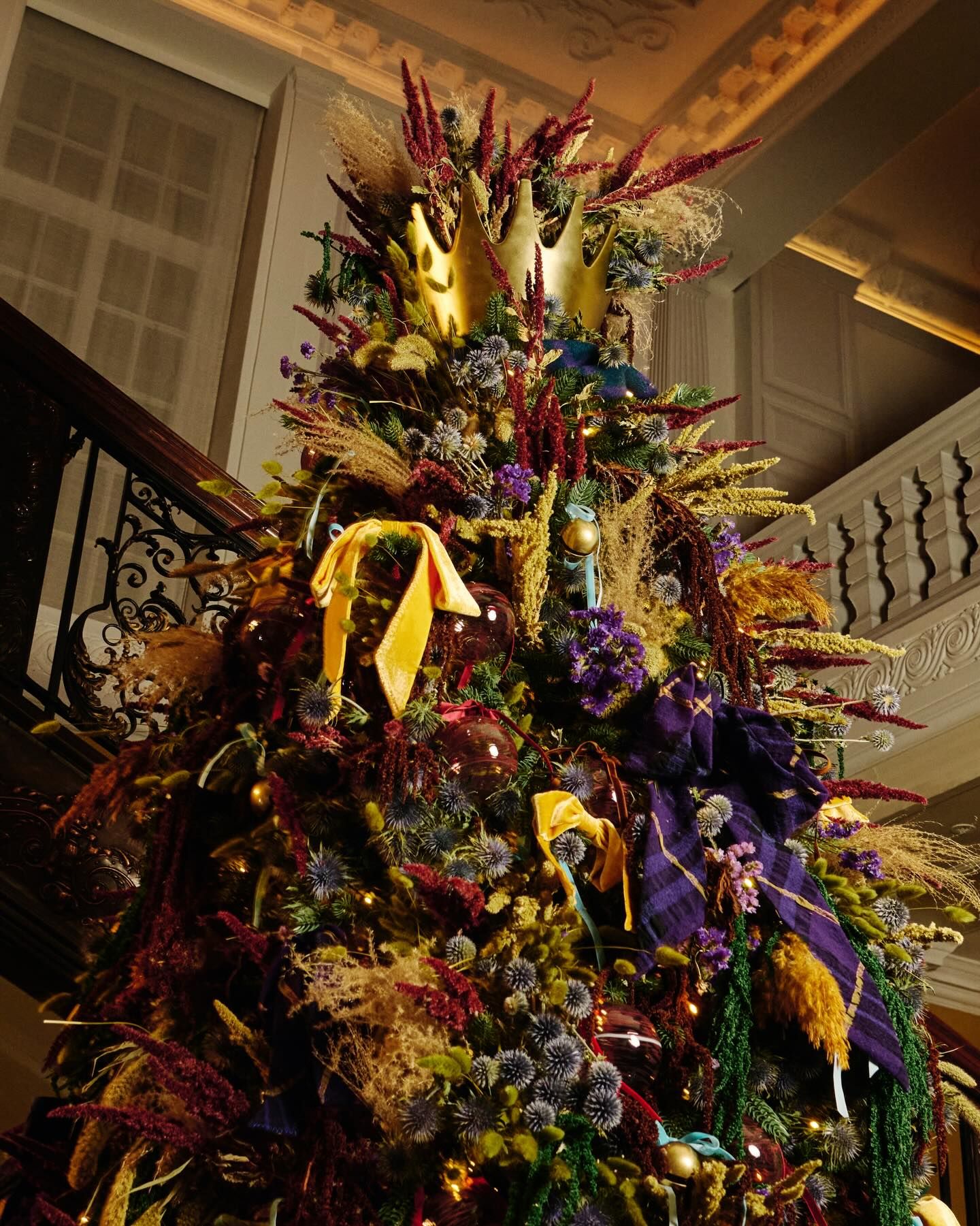 detail of theBurberry Christmas Tree at Claridges with a golden crown as tree topper and burberry check fabric bows...