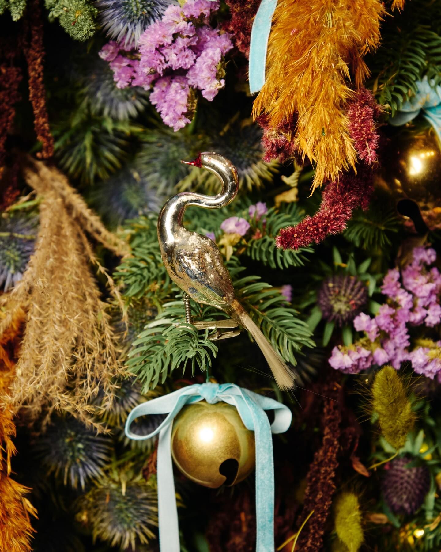 detail of the Burberry Christmas Tree at Claridges with dried foliage decorations brass bells thistles and a bird