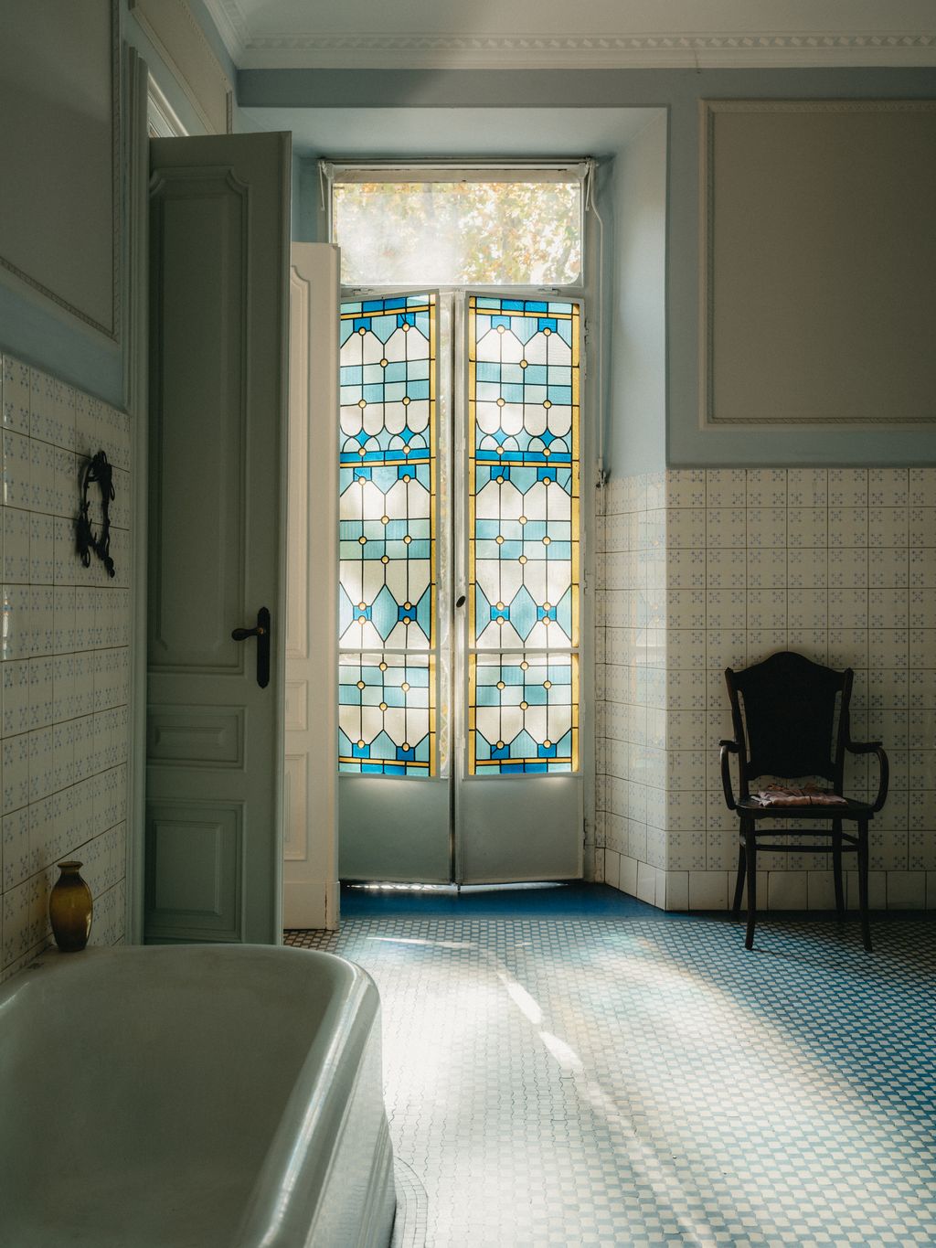 Image may contain Door Chair Furniture Bathing Bathtub Person Tub Architecture Building Housing and House