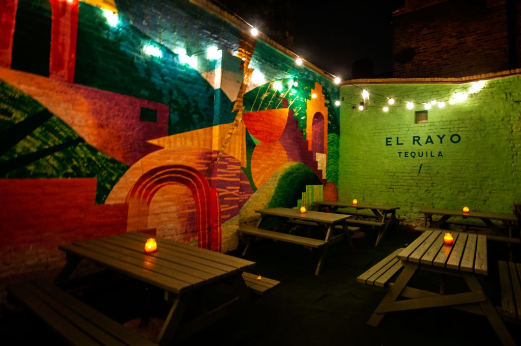 Image may contain City Road Street Urban Art Painting Lighting Bench and Furniture