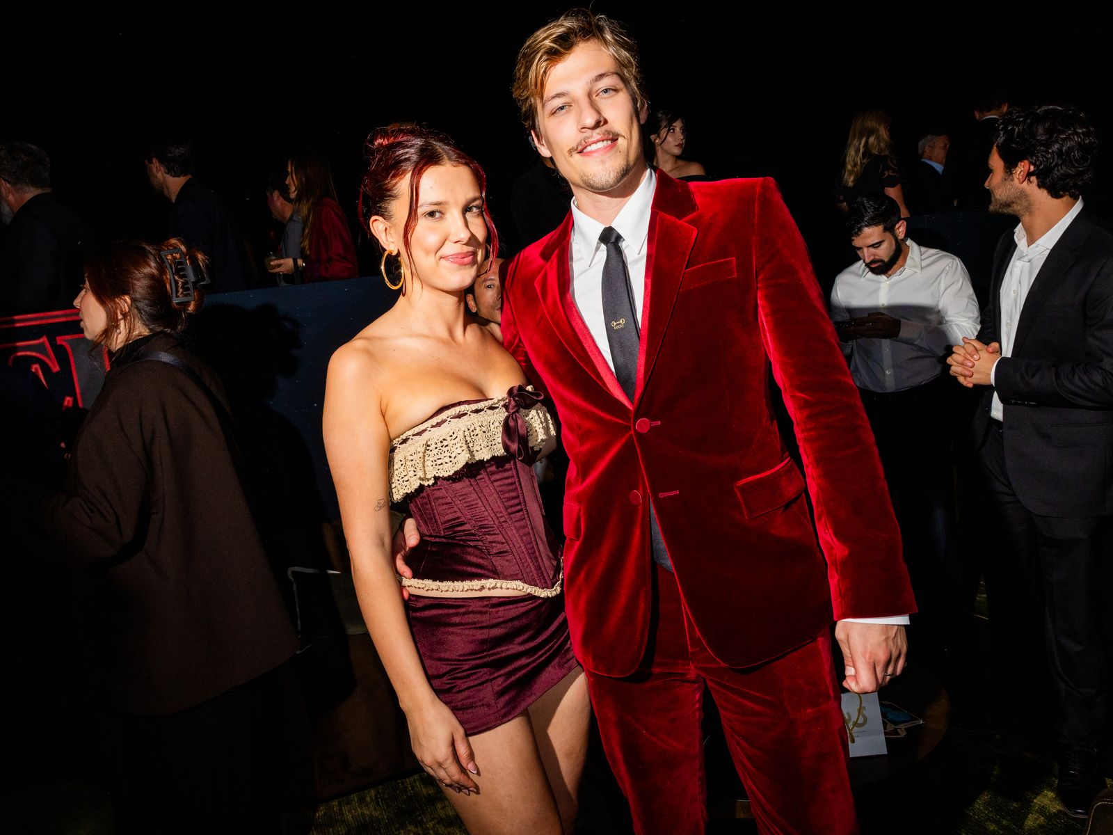 Image may contain Millie Bobby Brown Ahu Yağtu Jennifer Garner Fashion Velvet Clothing Formal Wear Suit and Adult