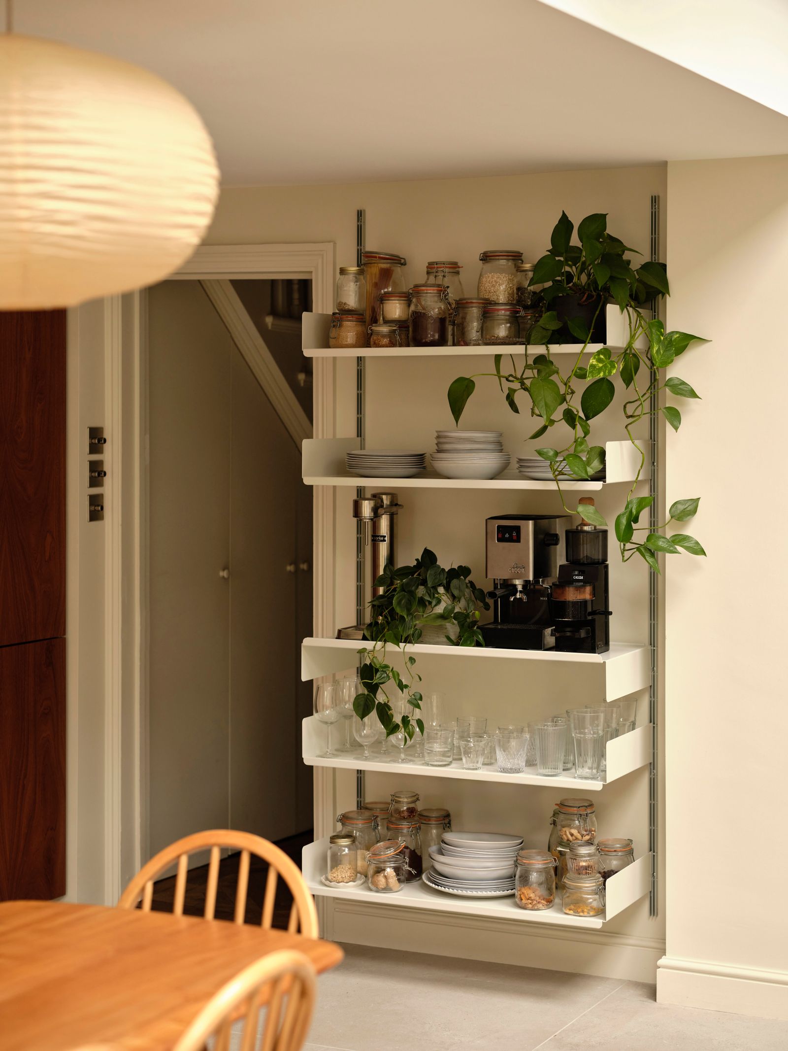 Image may contain Shelf Indoors Interior Design Chair Furniture Lamp Plant Cup and Pantry