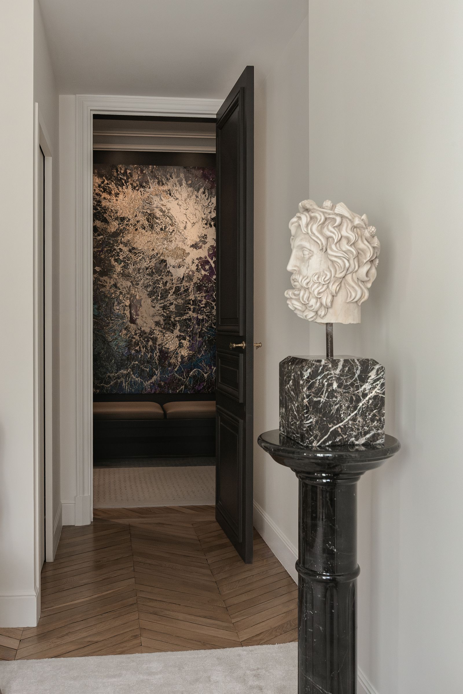 A marble head of Neptune on a marble pedestal. In the entrance hall Kirschs largeformat abstract expressionist painting...