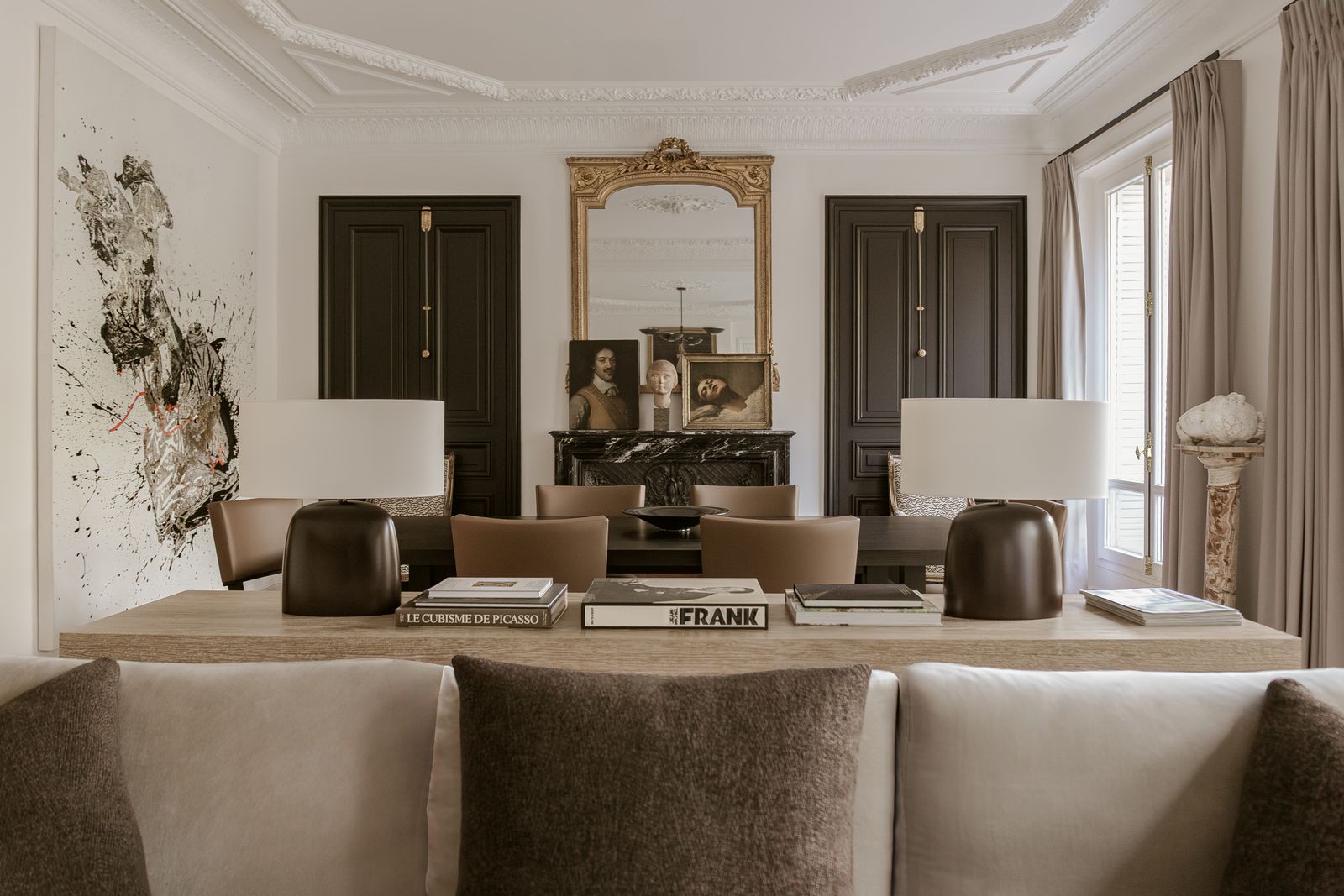 Behind the sofa by Liaigre upholstered in Pierre Frey fabric are two lamps . The pillow fabric is from Larsen and the...