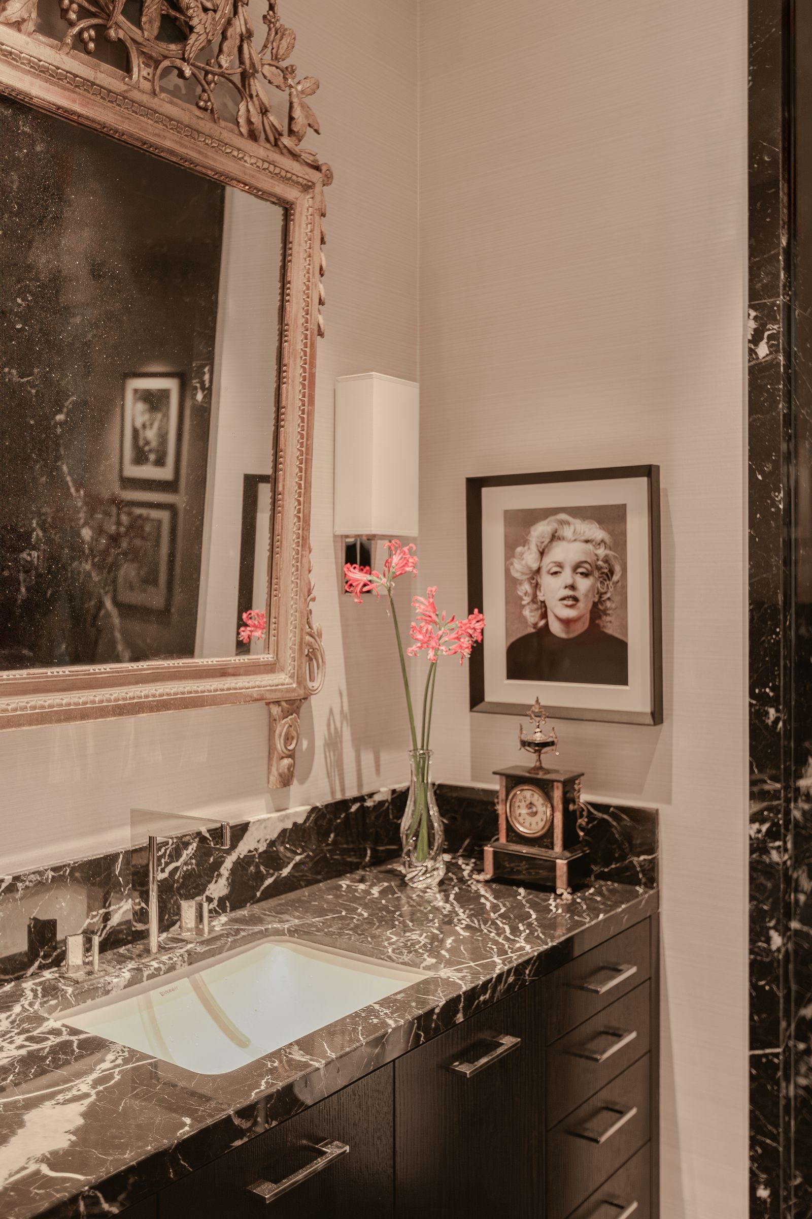bathroom with dark marble custom vanity unit with antique mirror