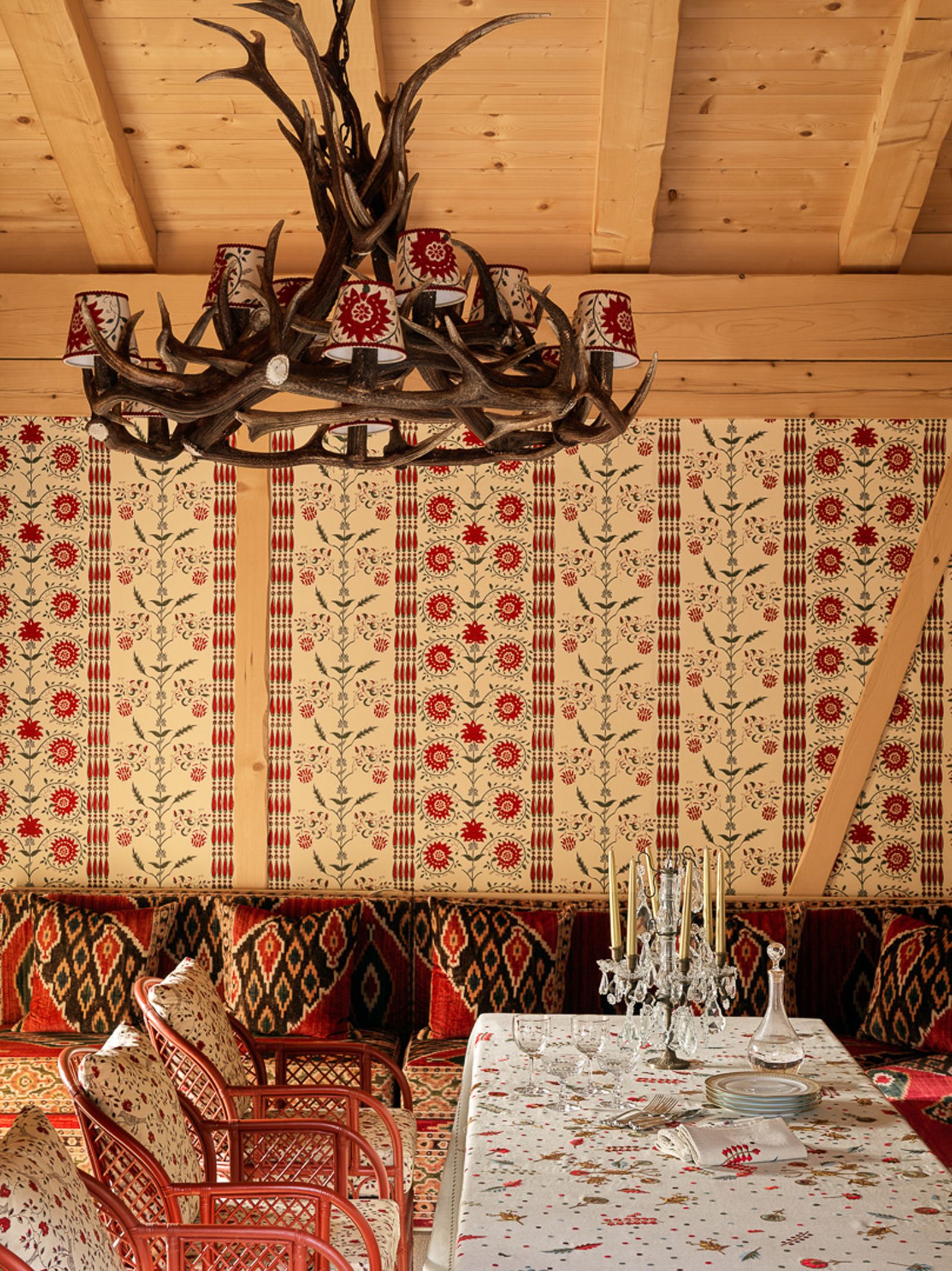 Image may contain Indoors Interior Design Home Decor Antler Chandelier Lamp Furniture Table Tabletop and Chair