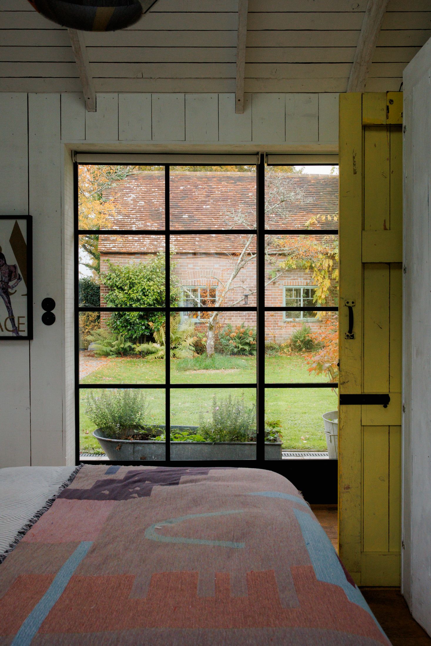 Image may contain Indoors Interior Design French Window Window Plant Bed Furniture Home Decor and Person