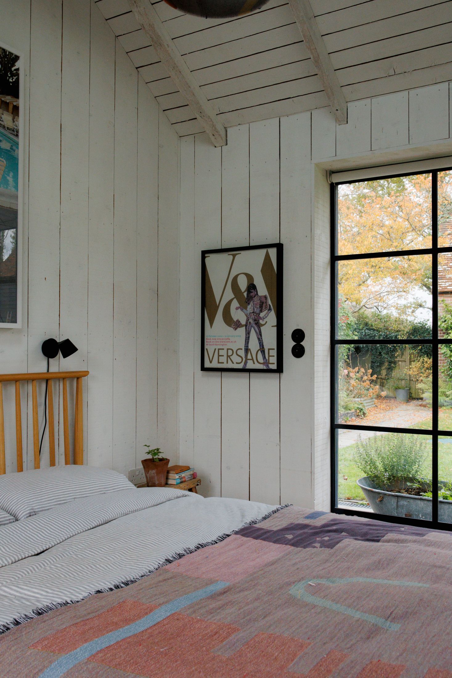 Image may contain Indoors Interior Design Door Wood Panels Person Bed Furniture Art Painting and Architecture