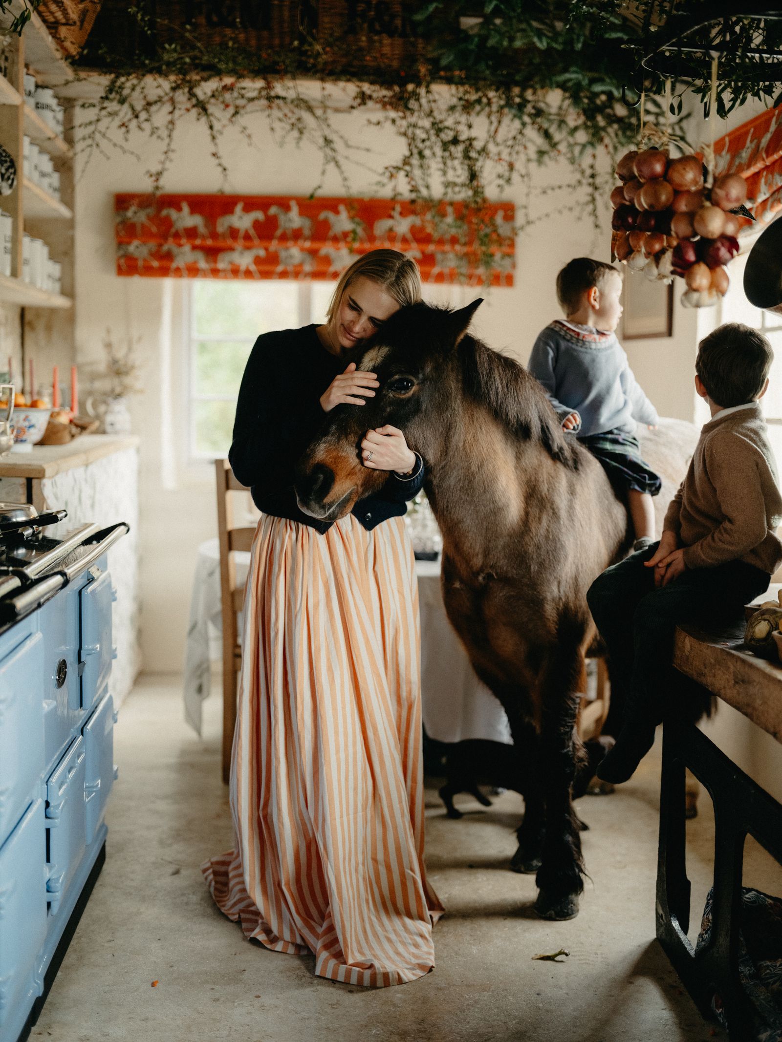 Image may contain Brooke Shields Clothing Dress Adult Person Baby Wedding People Indoors Kitchen and Formal Wear