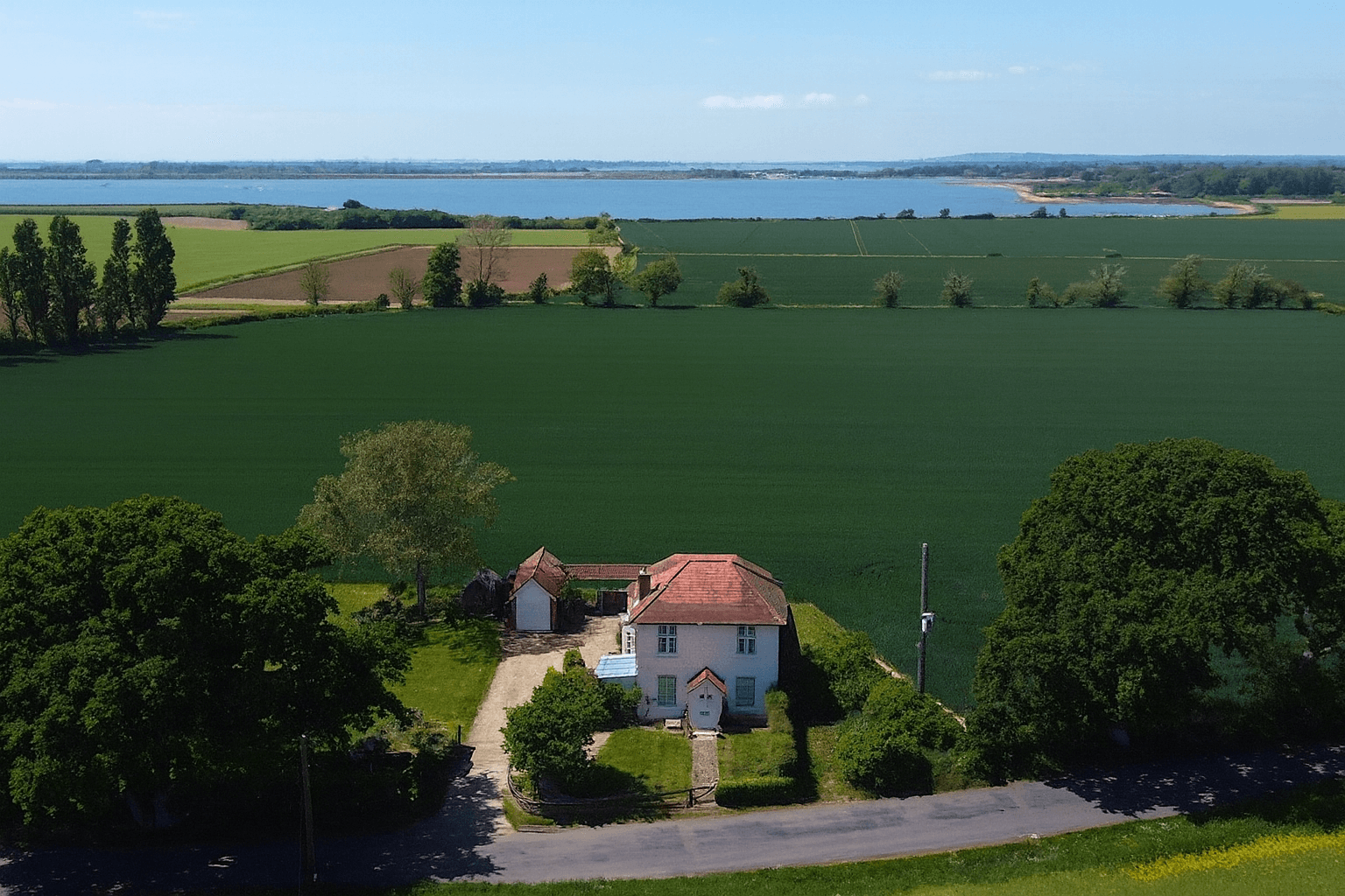 Image may contain: Outdoors, Architecture, Building, Nature, Countryside, Housing, Rural, House, Plant, and Aerial View