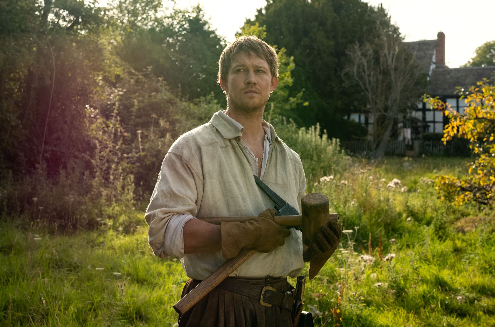 Image may contain Joe Alwyn Clothing Glove Face Head Person Photography Portrait Plant Tree Garden and Nature