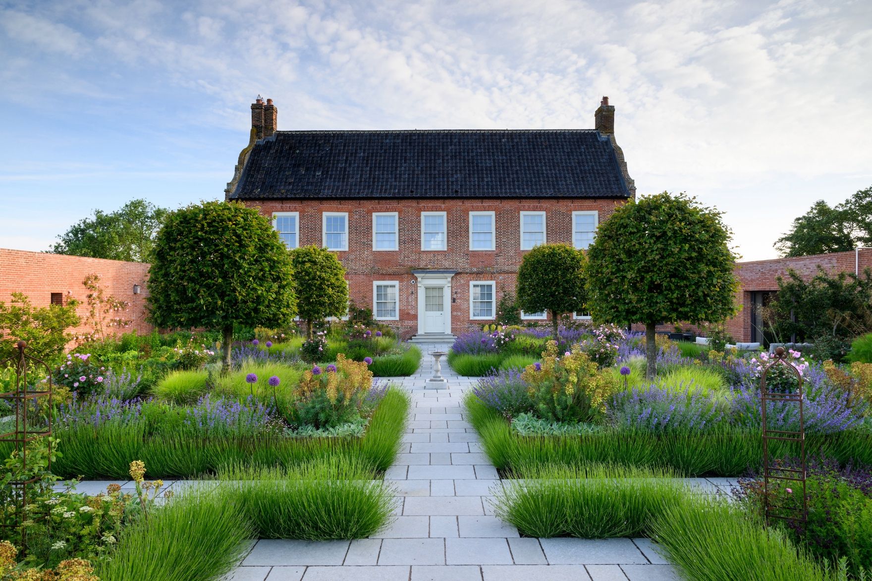 Image may contain: Architecture, Building, Cottage, House, Housing, Grass, Plant, Garden, Nature, Outdoors, Fence, and Hedge