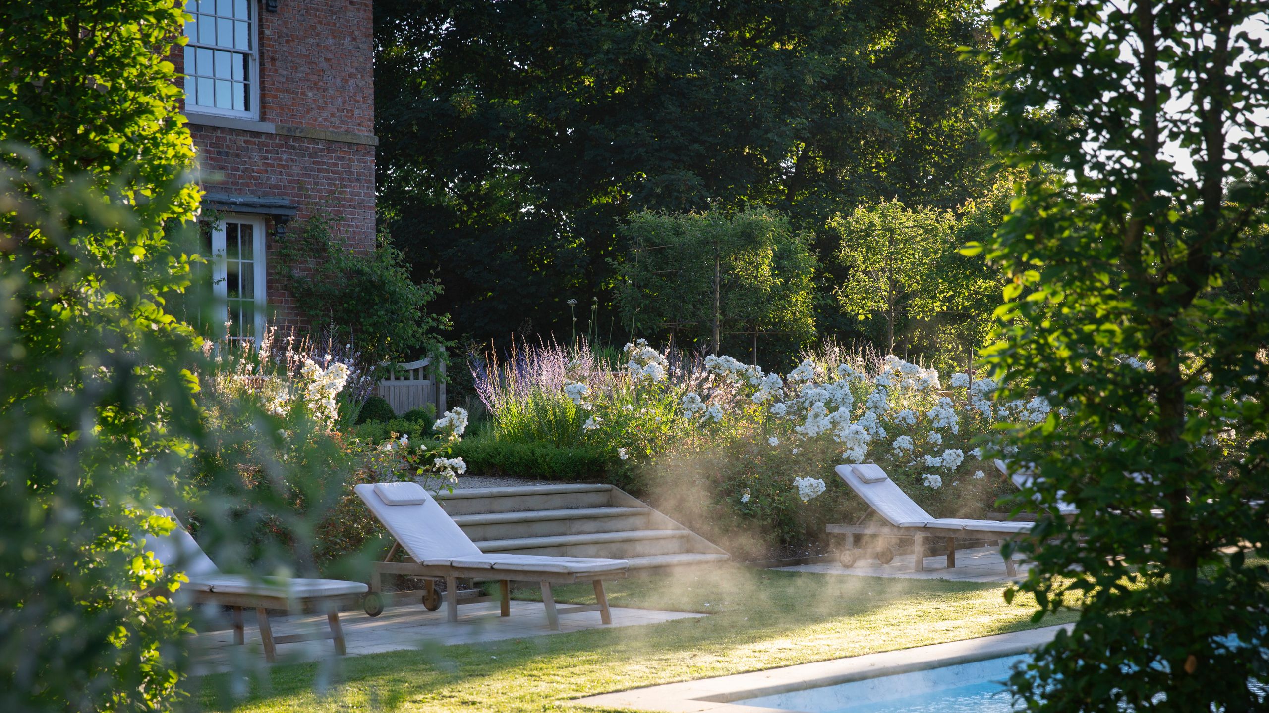 Image may contain: Backyard, Nature, Outdoors, Yard, Grass, Plant, Garden, Furniture, Pool, Water, Chair, Lawn, and Park